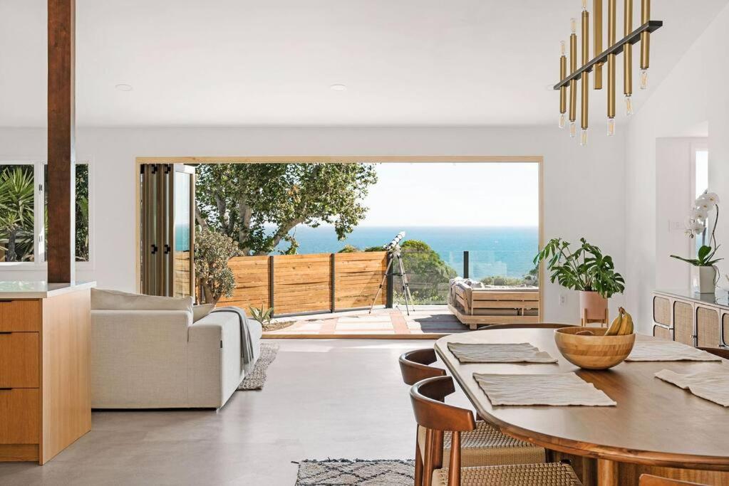 a living room with a table and a couch at The Broad Beach House in Malibu