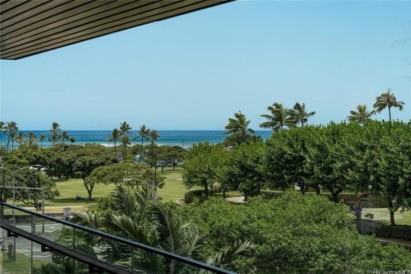 a view of the ocean from the balcony of a resort at Park lane 2/2 in Honolulu