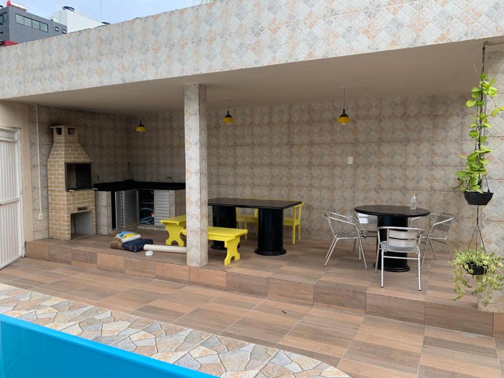 a patio with a table and a dining table at Casa Porto in Porto De Galinhas
