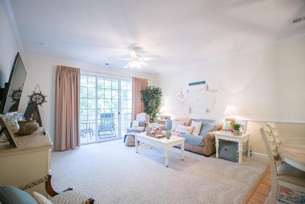 a living room with a couch and a table at Barefoot Resort - Arbor Trace 523 - Windy Hill in North Myrtle Beach