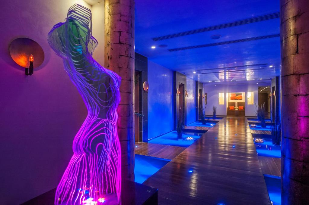 a purple and blue room with a dress on the wall at Amathus Beach Hotel Limassol in Limassol