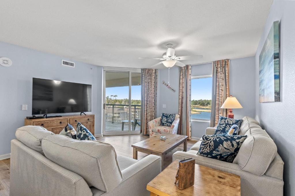 a living room with two couches and a flat screen tv at Tilghman Beach & Golf Resort 6015 - 2nd Row - Cherry Grove in Myrtle Beach