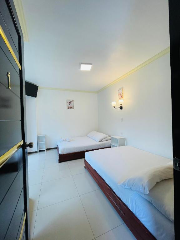 Postel nebo postele na pokoji v ubytování Hostal Balcon del Cielo
