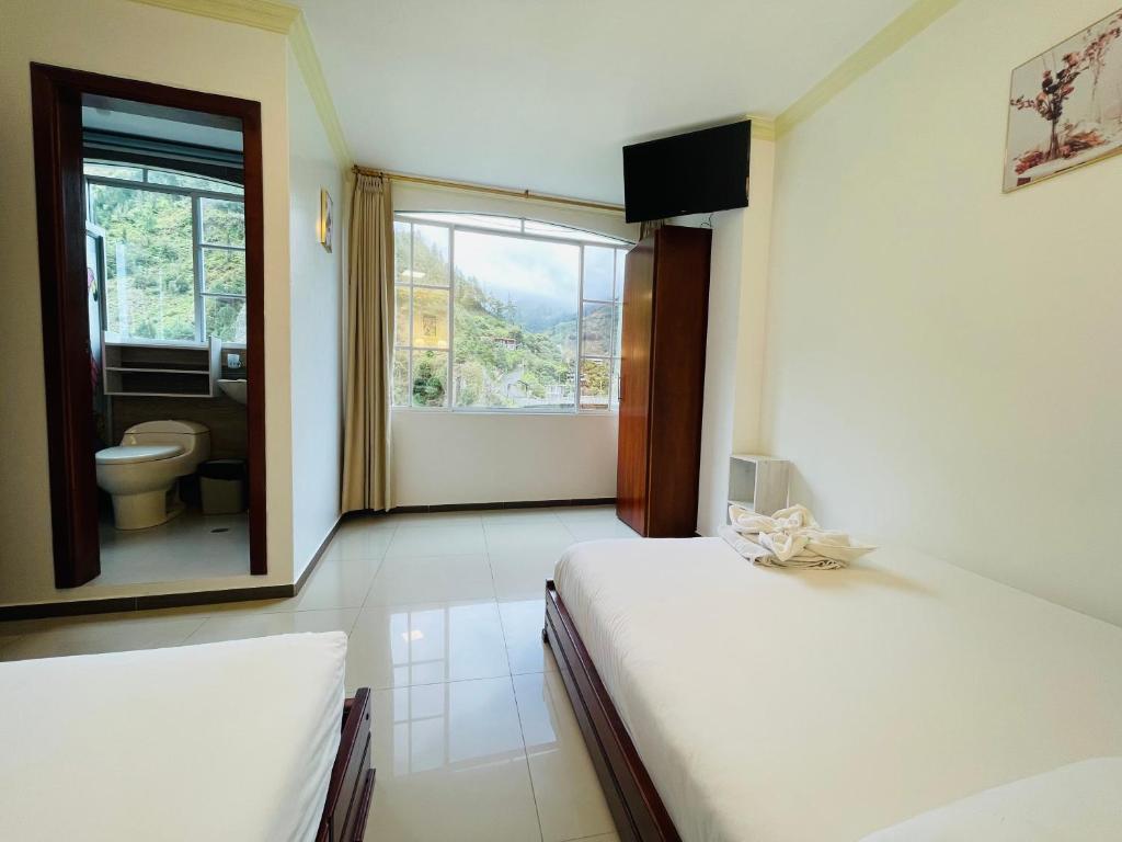 Postel nebo postele na pokoji v ubytování Hostal Balcon del Cielo