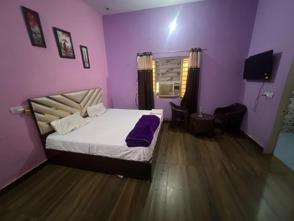 - une chambre avec un lit et un mur violet dans l'établissement OYO Hotel Star 7, à Palwal