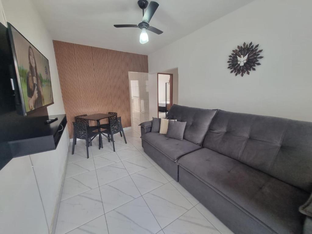 een woonkamer met een bank en een tafel bij Casa nova e confortável próxima ao Santuário in Aparecida