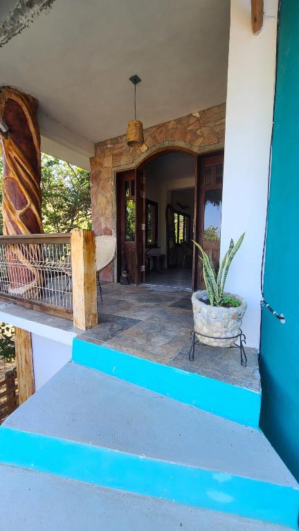 a porch of a house with a potted plant at Mar de Fondo in Puerto Escondido