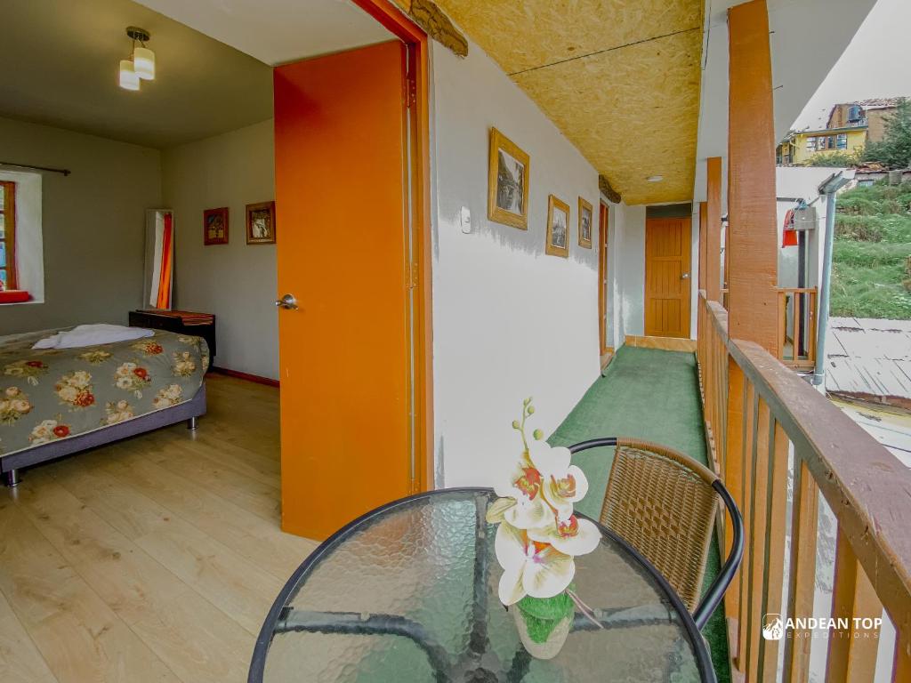 a balcony with a glass table and a bed at Central Plaza Apartments in Cusco