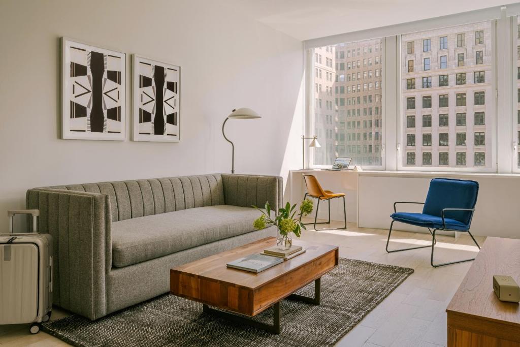 a living room with a couch and a coffee table at Sonder Battery Park in New York
