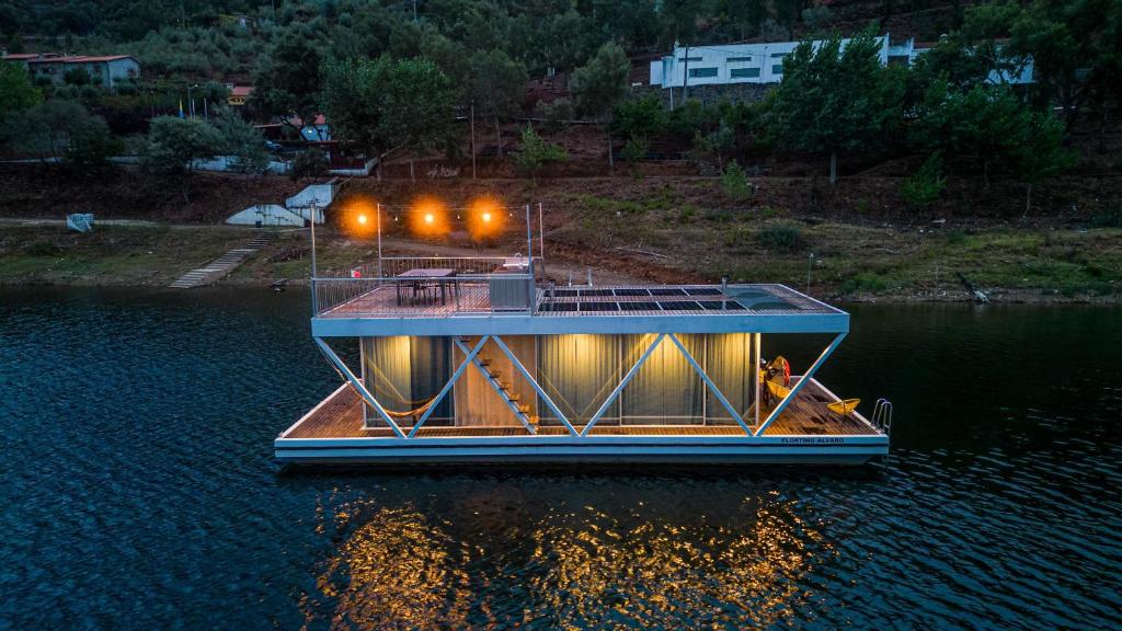 a house boat in the water at night at Floating Álvaro in Alvaro