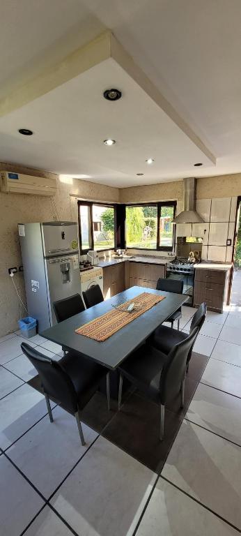 a large kitchen with a table and chairs in it at Departamentos Merceditas in San Rafael