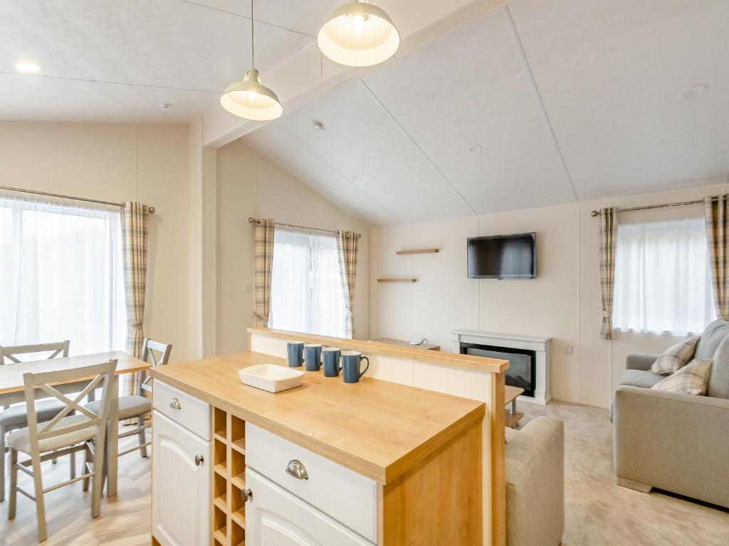uma cozinha e sala de estar com um sofá e uma mesa em Roseberry Topping - Uk42937 em Great Broughton