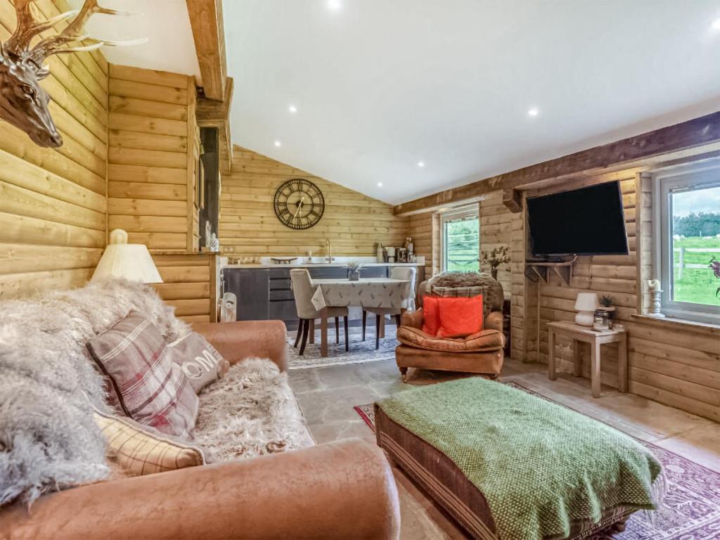 a living room with a couch and a dining room at Dai Boy Cabin - Uk46403 in Cowbridge