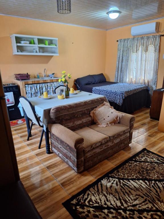 a living room with a table and a couch at Valsalms in Chaguanas