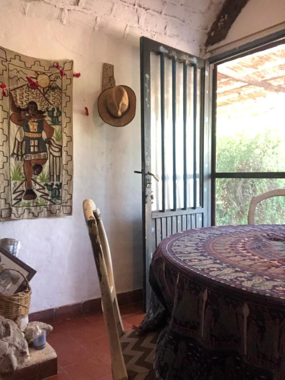 a room with a table and a picture on the wall at Sonqo Wasi in Cruz del Eje