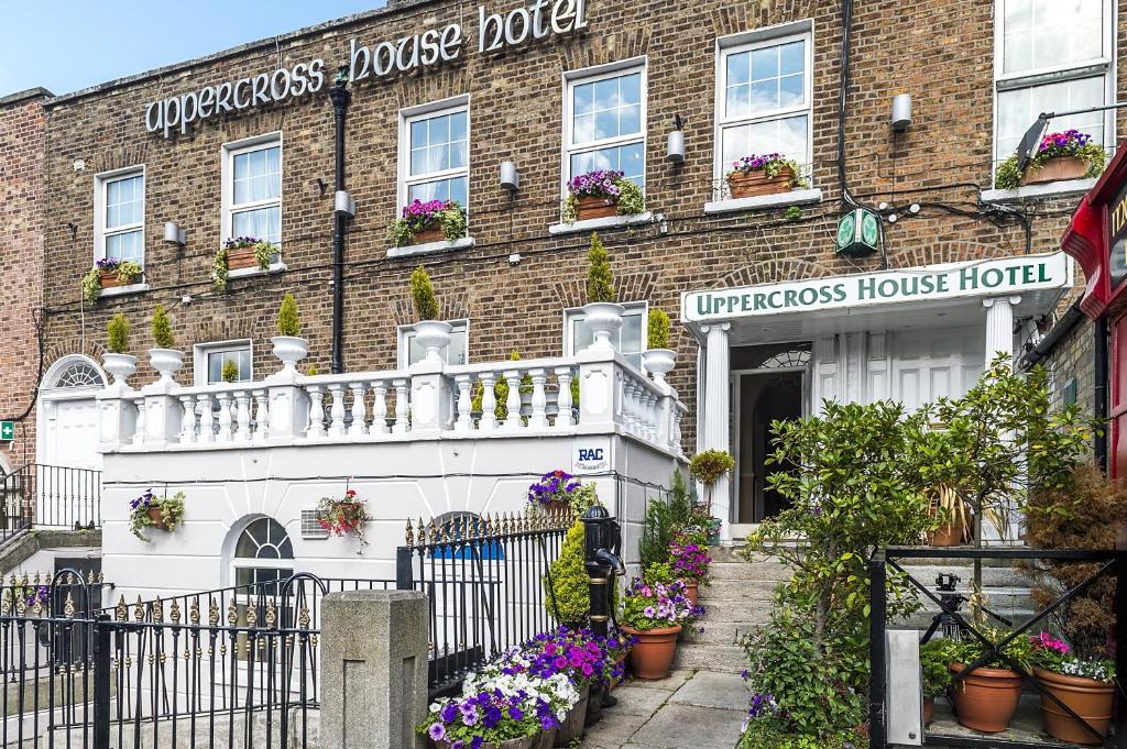 a brick building with flowers in front of it at Uppercross House Hotel in Dublin