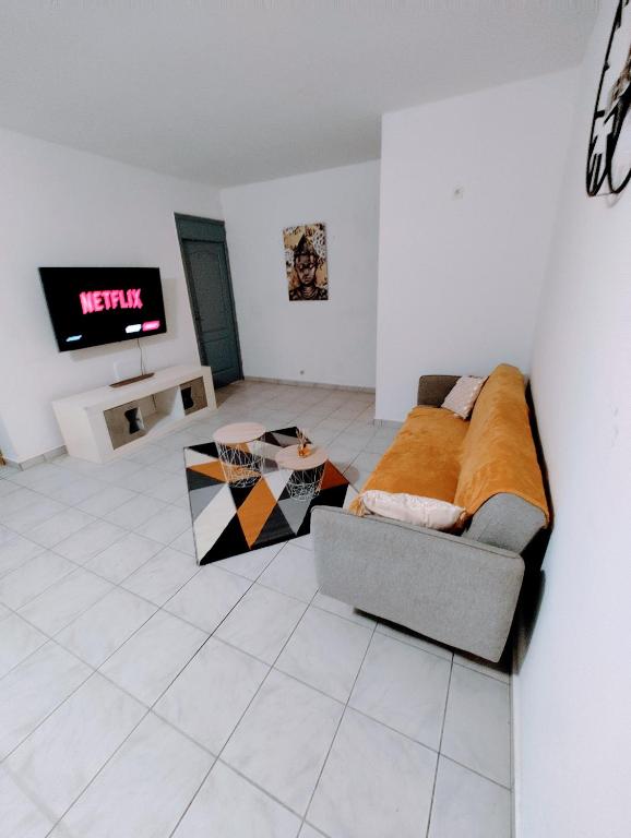 Posezení v ubytování Le Nil Appartement Cosy tout confort