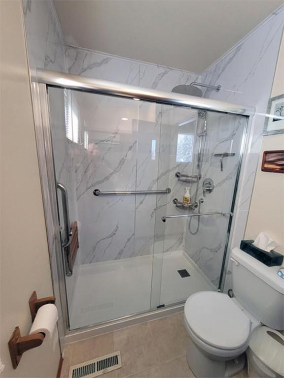 a bathroom with a shower and a toilet at The Dewberry Homestay B&B in Edmonton