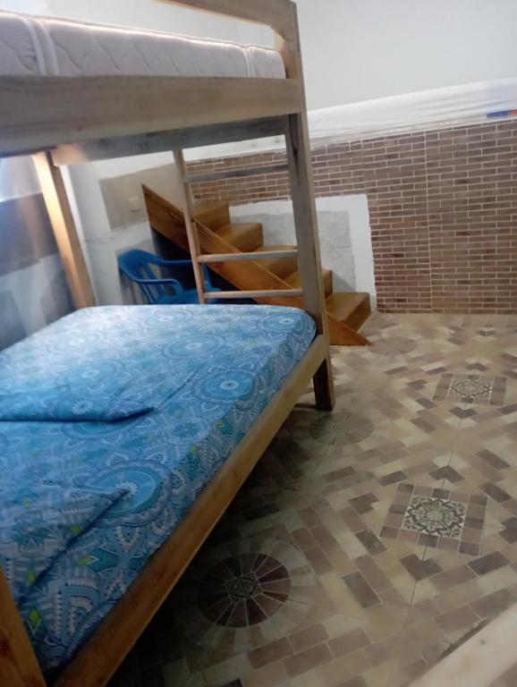 a bedroom with two bunk beds and a tile floor at Cabaña Villa Eugenia in Rincón