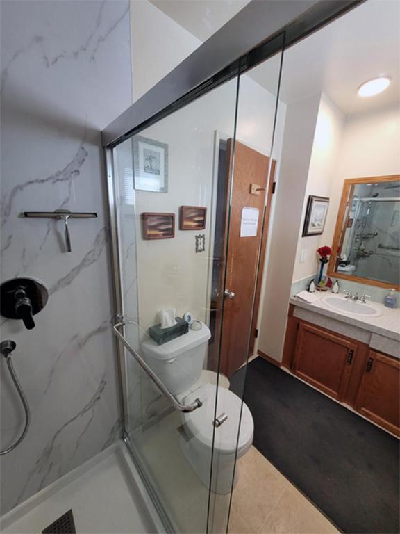 a bathroom with a shower and a toilet and a sink at The Dewberry Homestay B&B in Edmonton