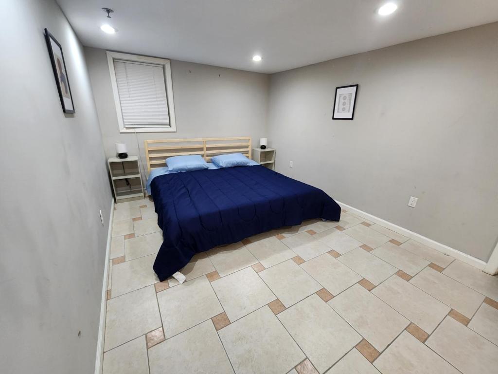 a bedroom with a bed and a tiled floor at Cozy & Classy 1-Bed Close to NYC in Jersey City