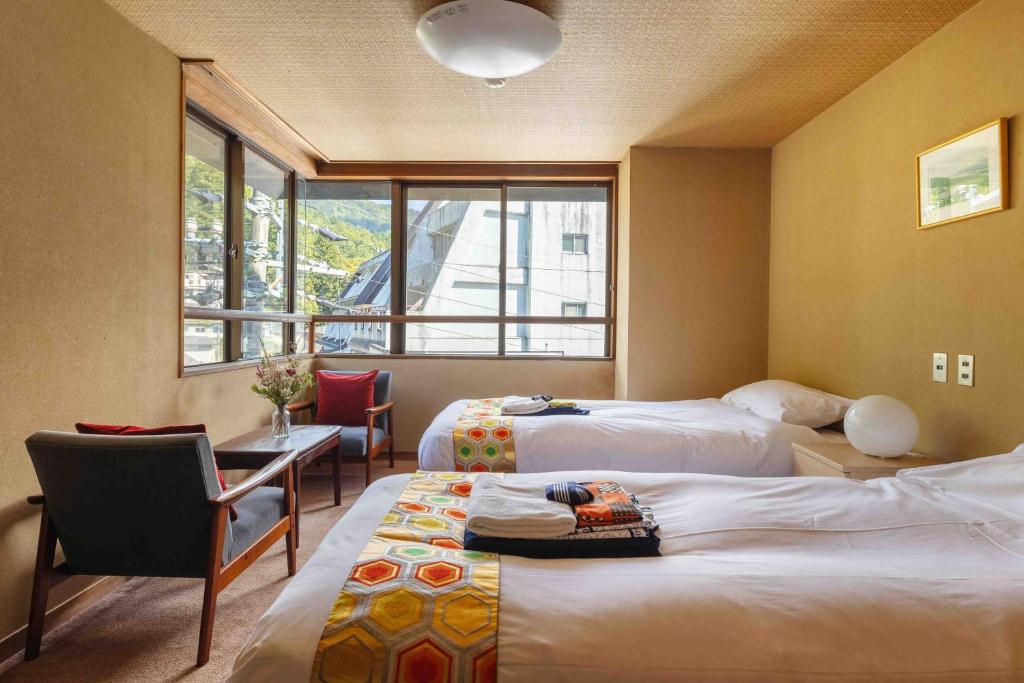 Postel nebo postele na pokoji v ubytování Nozawa View Hotel Shimataya
