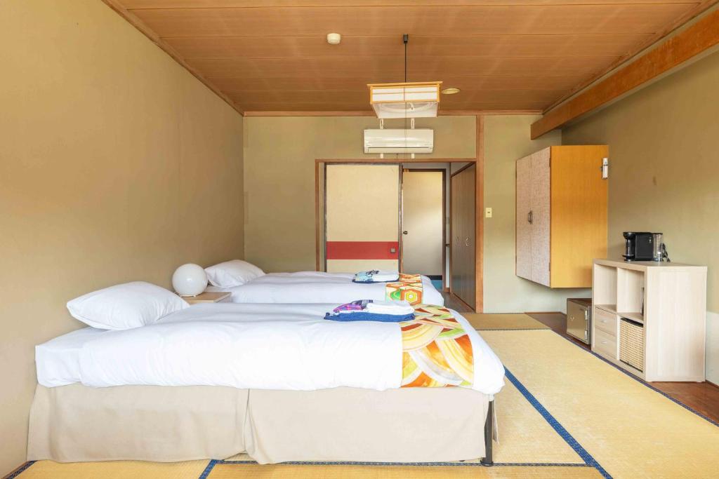 Postel nebo postele na pokoji v ubytování Nozawa View Hotel Shimataya
