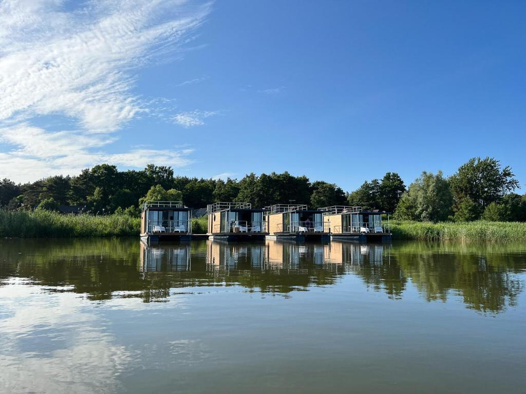 a group of boats sitting in the water at A comfortable house on the water for 6 people in Łazy