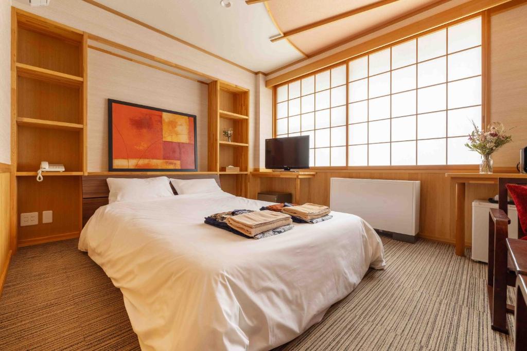 Postel nebo postele na pokoji v ubytování Nozawa View Hotel Shimataya