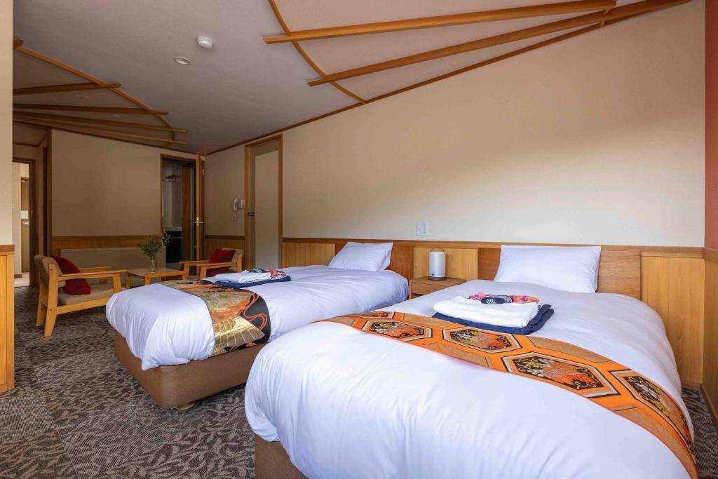 Postel nebo postele na pokoji v ubytování Nozawa View Hotel Shimataya