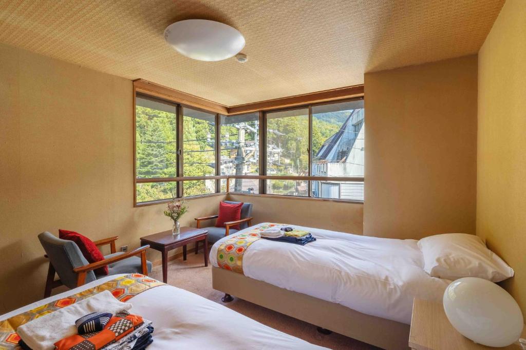 Postel nebo postele na pokoji v ubytování Nozawa View Hotel Shimataya