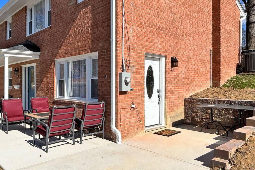 a patio with chairs and a table and a building at Centered Home in West Springfield