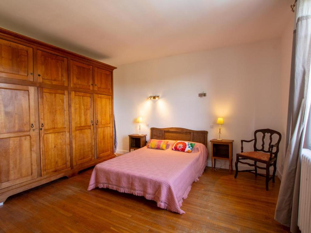 a bedroom with a bed and wooden cabinets at Gîte La Bachellerie, 4 pièces, 6 personnes - FR-1-616-294 in La Bachellerie