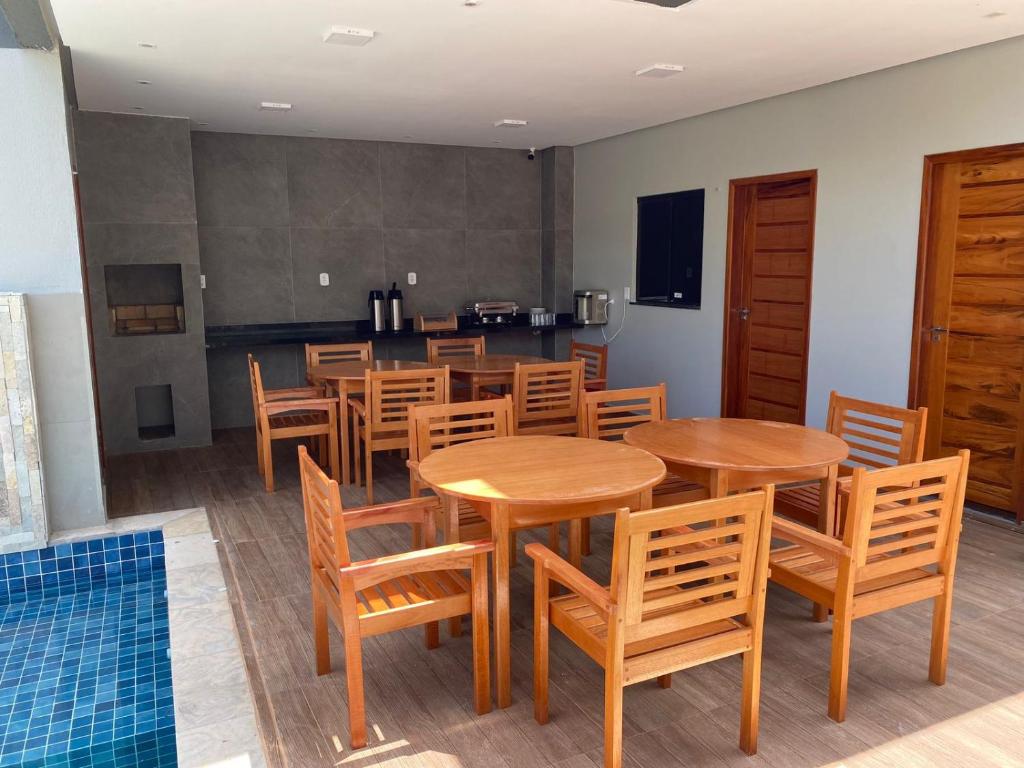 a dining room with wooden tables and chairs at POUSADA ALTER PARA TODOS in Alter do Chao