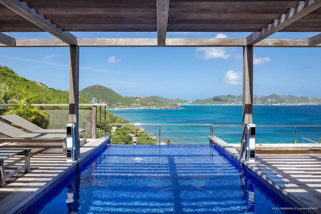 a swimming pool with a view of the ocean at Luxury Vacation Villa 6 in Pointe Milou