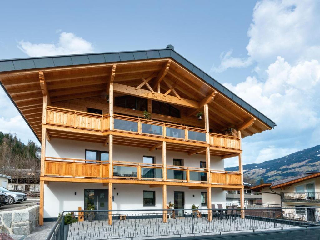 a large building with a wooden roof at Thunhaus Apartments with ski-storage in Uderns