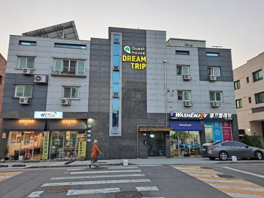 a person riding a skateboard in front of a building at DreamTrip Guesthouse in Incheon