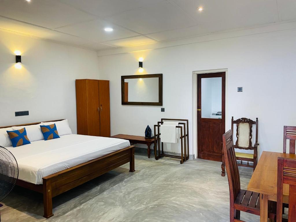 a bedroom with a bed and a table in it at Villa 754 in Dickwella