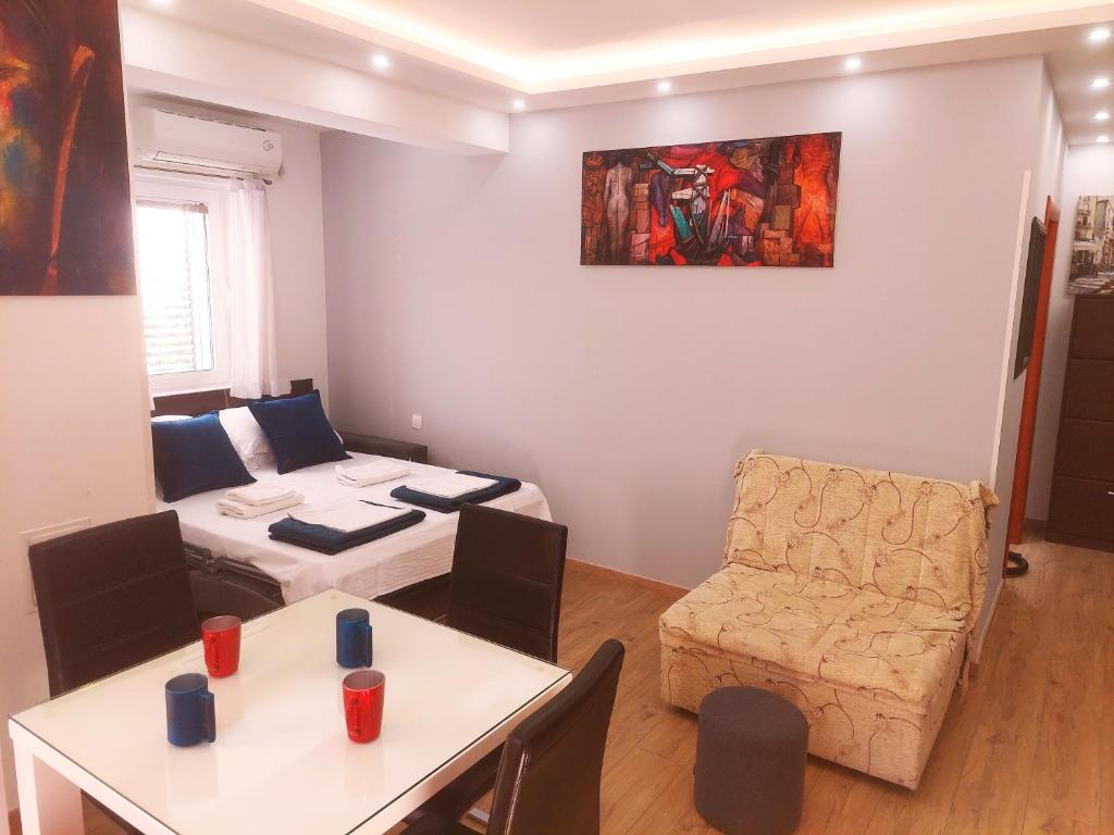 a small living room with a table and a couch at Apartments Nancy in Kotor