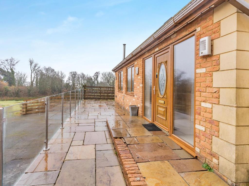 a brick building with a door on the side of it at Wernddu Fechan Bungalow - Uk42931 in Neath