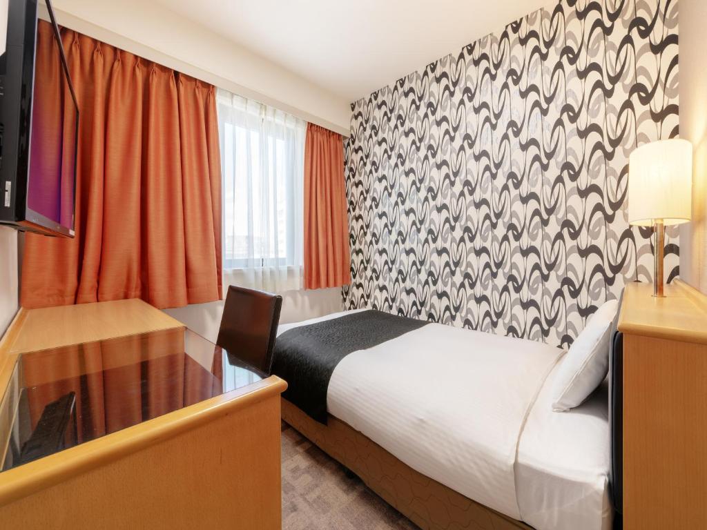 Postel nebo postele na pokoji v ubytování APA Hotel Maebashieki-Kita