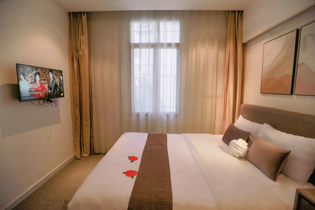 Postel nebo postele na pokoji v ubytování Keypad Hotel - 28 Dịch Vọng Hậu
