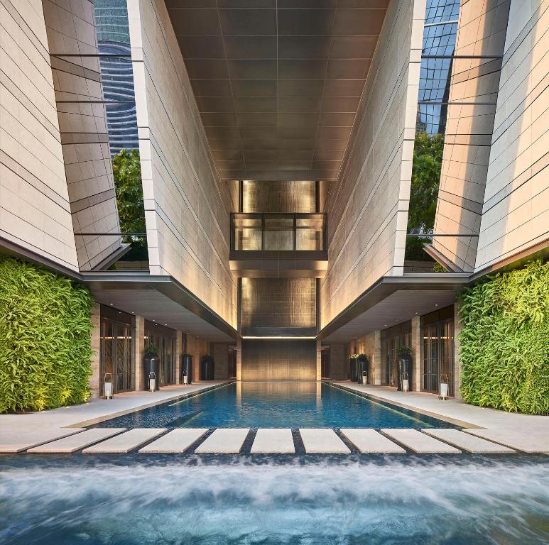 a swimming pool in the middle of a building at Rosewood Bangkok in Bangkok