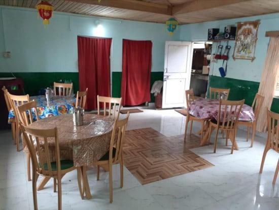 a dining room with a table and chairs at Resort Sonar Tari in Kalimpong