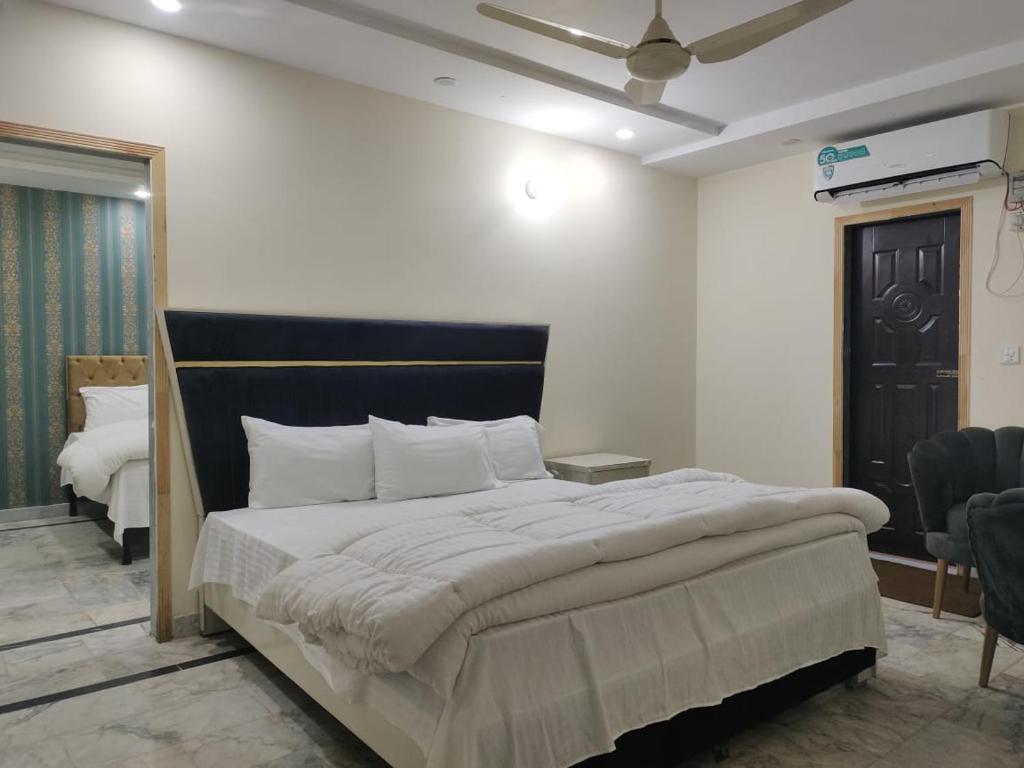 a bedroom with a large bed in a room at Executive lounge in Lahore