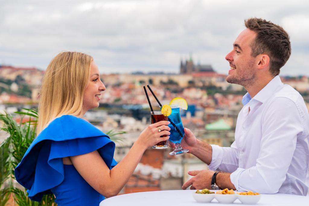 a man and a woman holding a drink at Wenceslas Square Hotel - Czech Leading Hotels in Prague