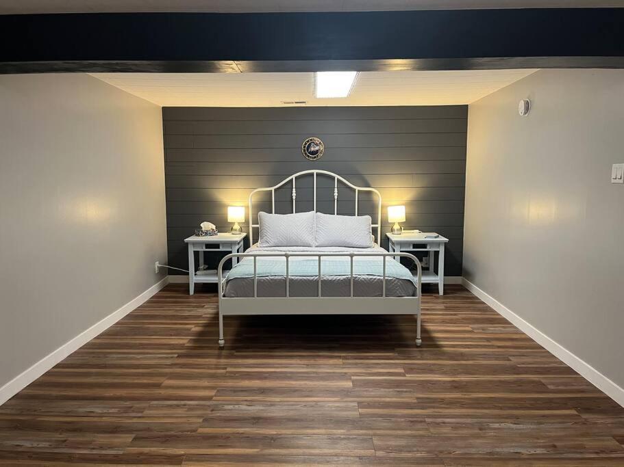 a bedroom with a bed and two night stands at Ambrosia Studio in Winnipeg