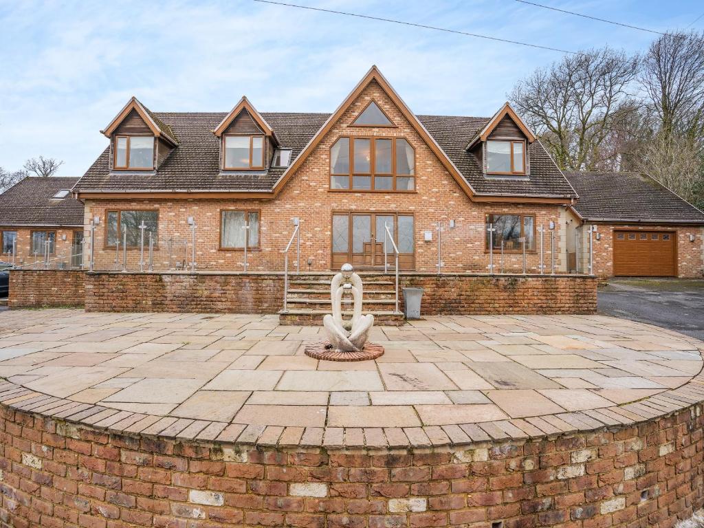 a brick house with a statue in front of it at Wernddu Fechan House - Uk42932 in Neath