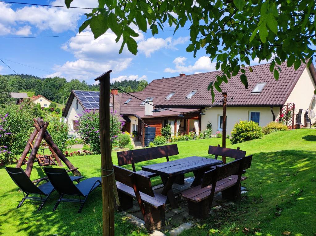 a picnic table and chairs in the yard of a house at Dom Kowala in Jankowce