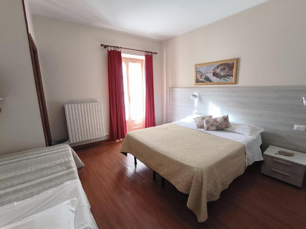 Postel nebo postele na pokoji v ubytování Nuovo Hotel Giardini
